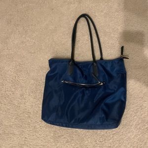 A New Day tote back with gold zipper and black handle